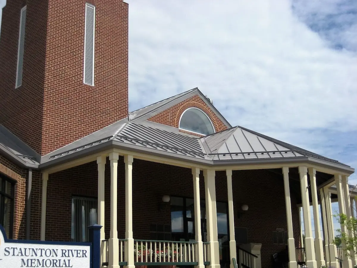 Skilled roofing craftsmen working on a residential roof in Kirtland